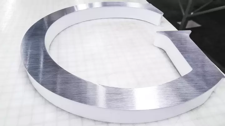 Halo-lit channel letters for illuminated display with a metallic finish
