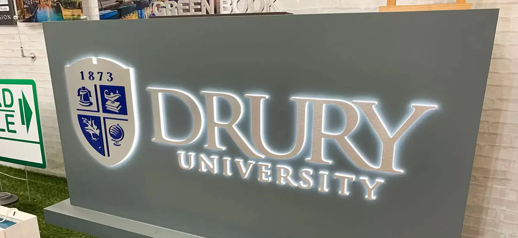 Halo-lit signs for Drury University showing brand name and logo on a grey background
