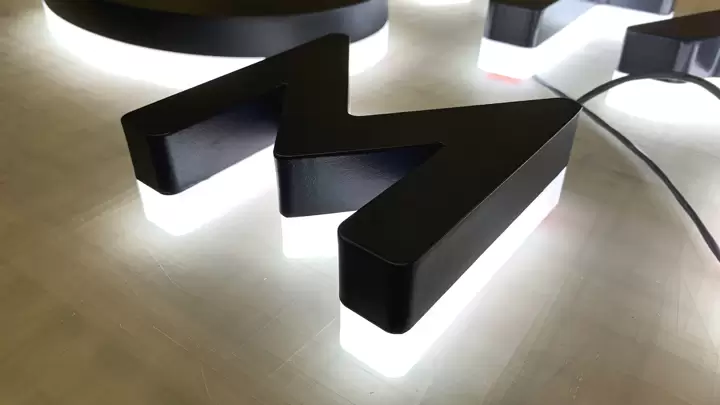 Halo-lit signs for half side lit stand alone display in black