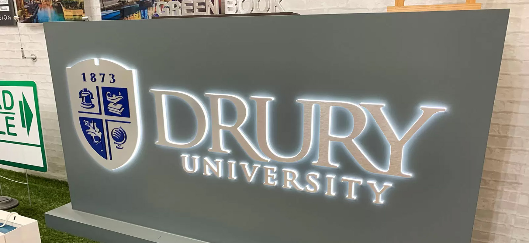 Drury University halo-lit signs in a free-standing style made of brushed aluminum and acrylic