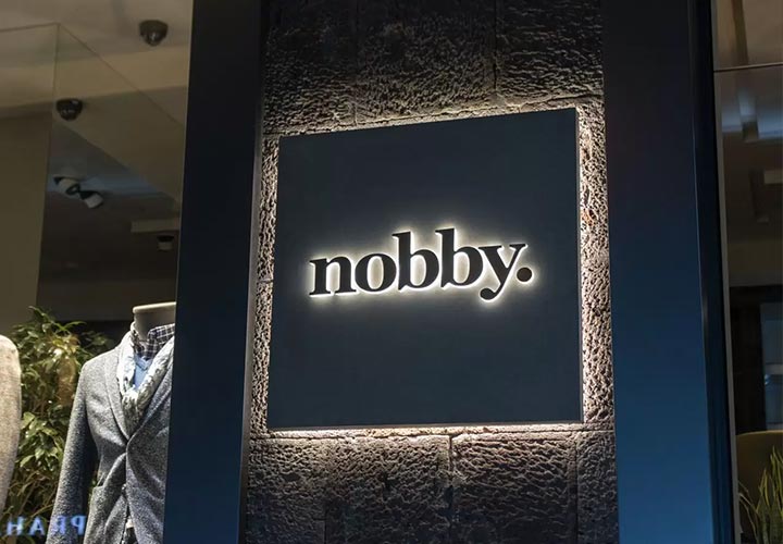 Nobby halo-lit sign spelling the brand name made of aluminum and acrylic for exterior branding