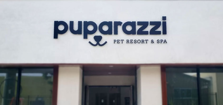 Wall-mounted outdoor signage design idea from Puparazzi Pet Resort & Spa