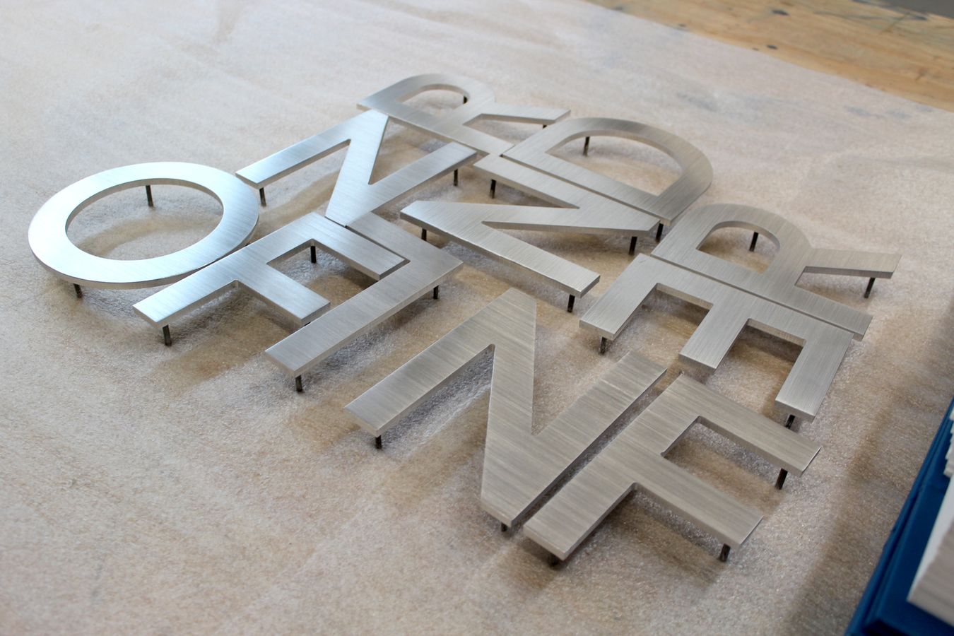 custom-cut 3d sign letters made of brushed aluminum before the signage installation