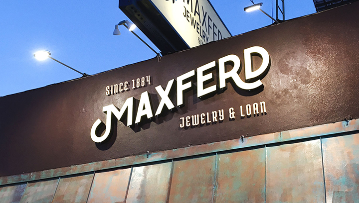 Maxfred lit storefront channel letters displaying the brand name made of aluminum and acrylic