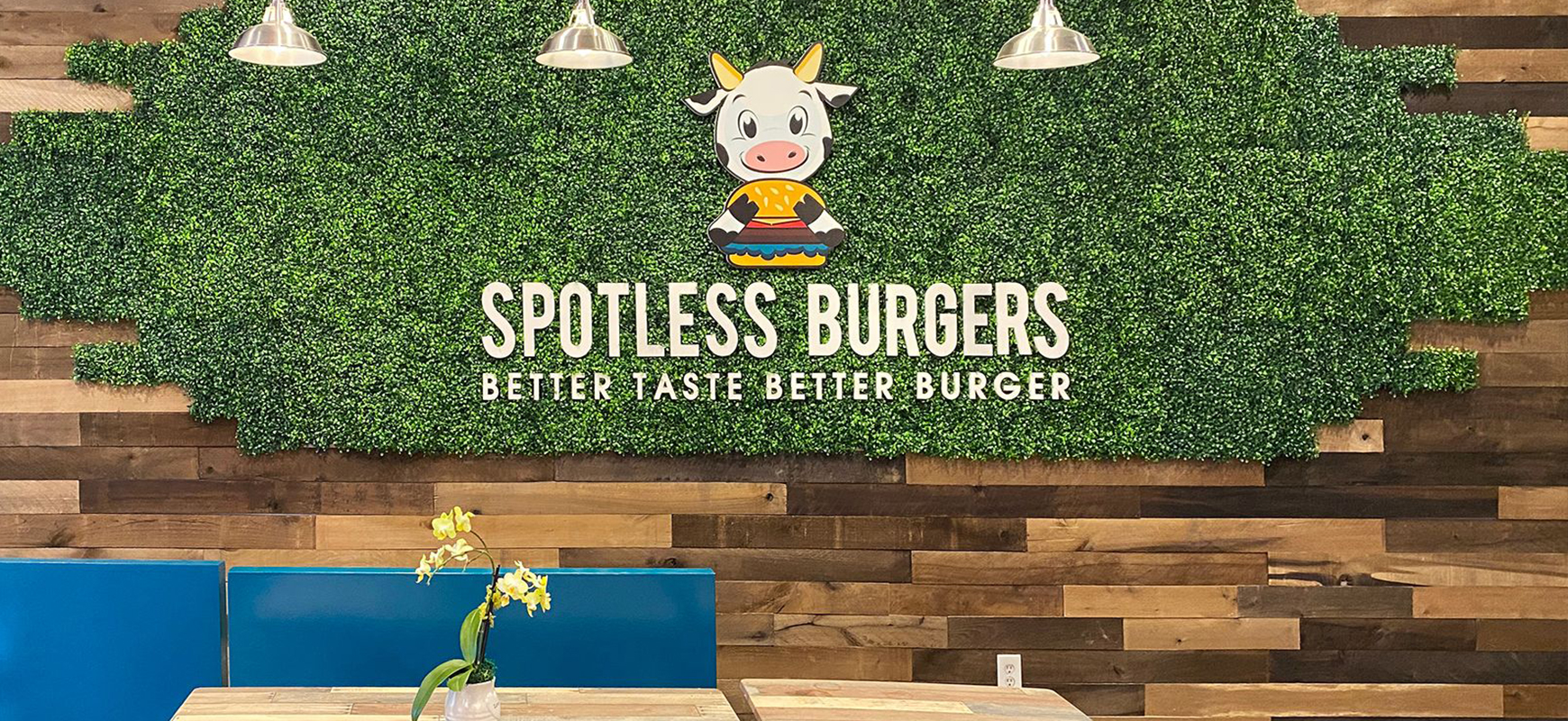 Spotless Burgers restaurant signs with the brand name, slogan and cow-shaped logo made of PVC