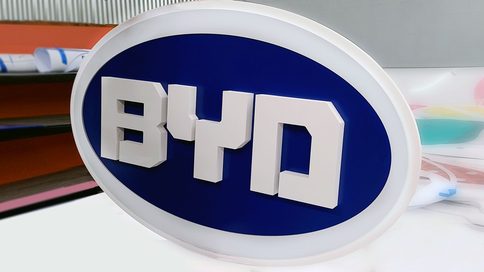 BYD 3d logo sign in an oval shape painted in white and blue made of PVC and styrene