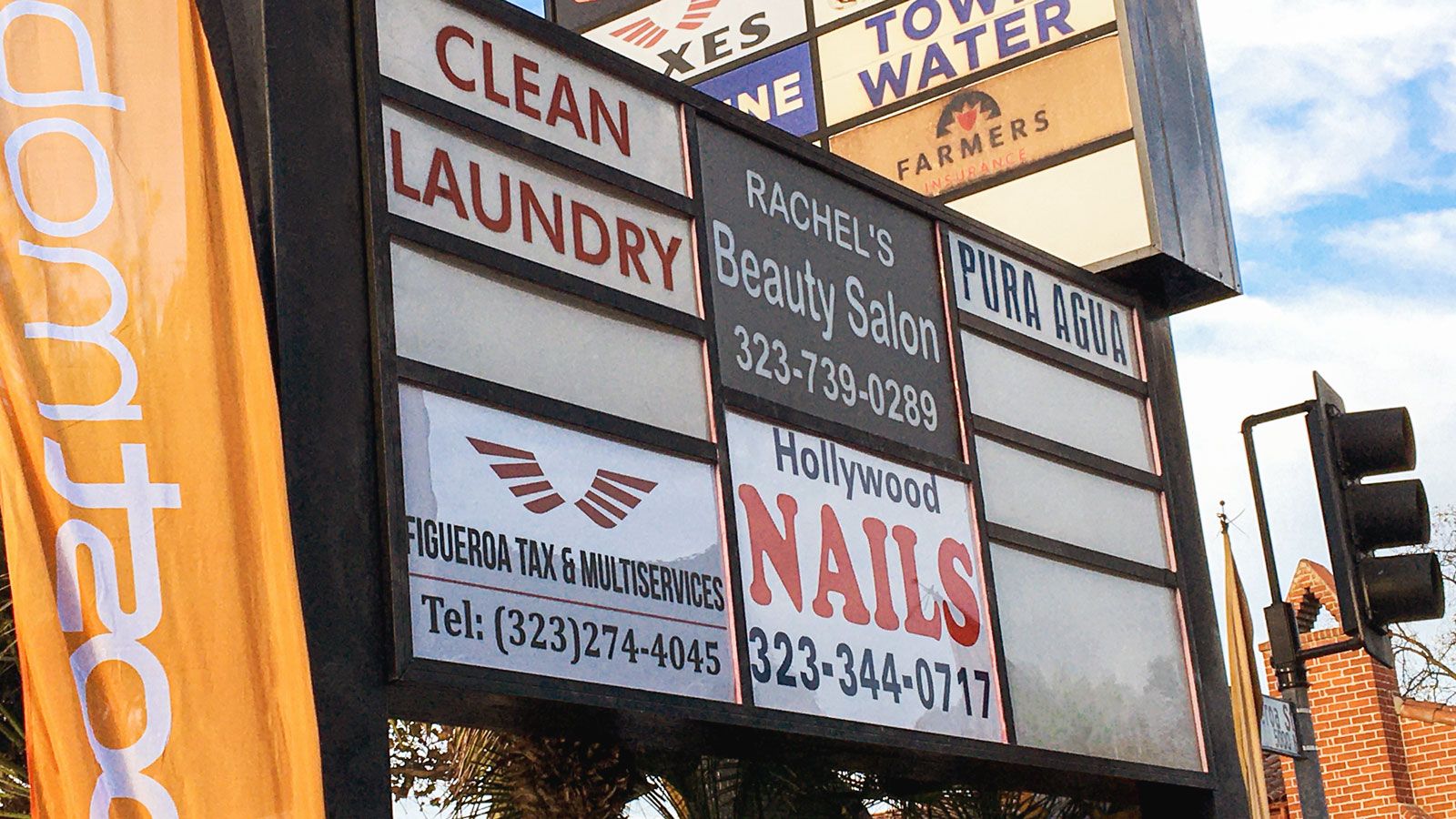 Figueroa Tax & Multiservices light box sign with business number made of aluminum and acrylic