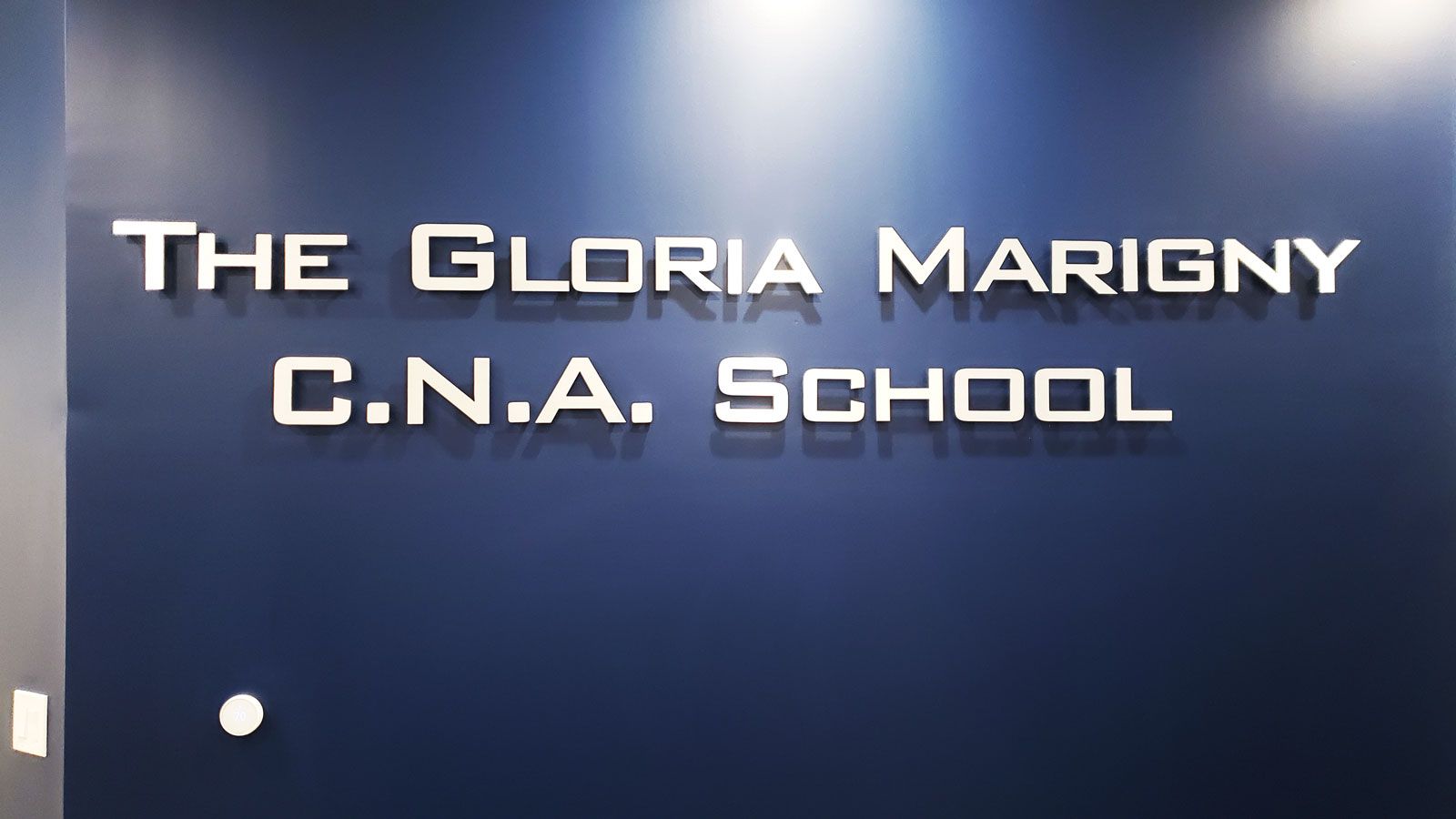 The Gloria Marigny C.N.A School 3d sign letters in white made of brushed aluminum