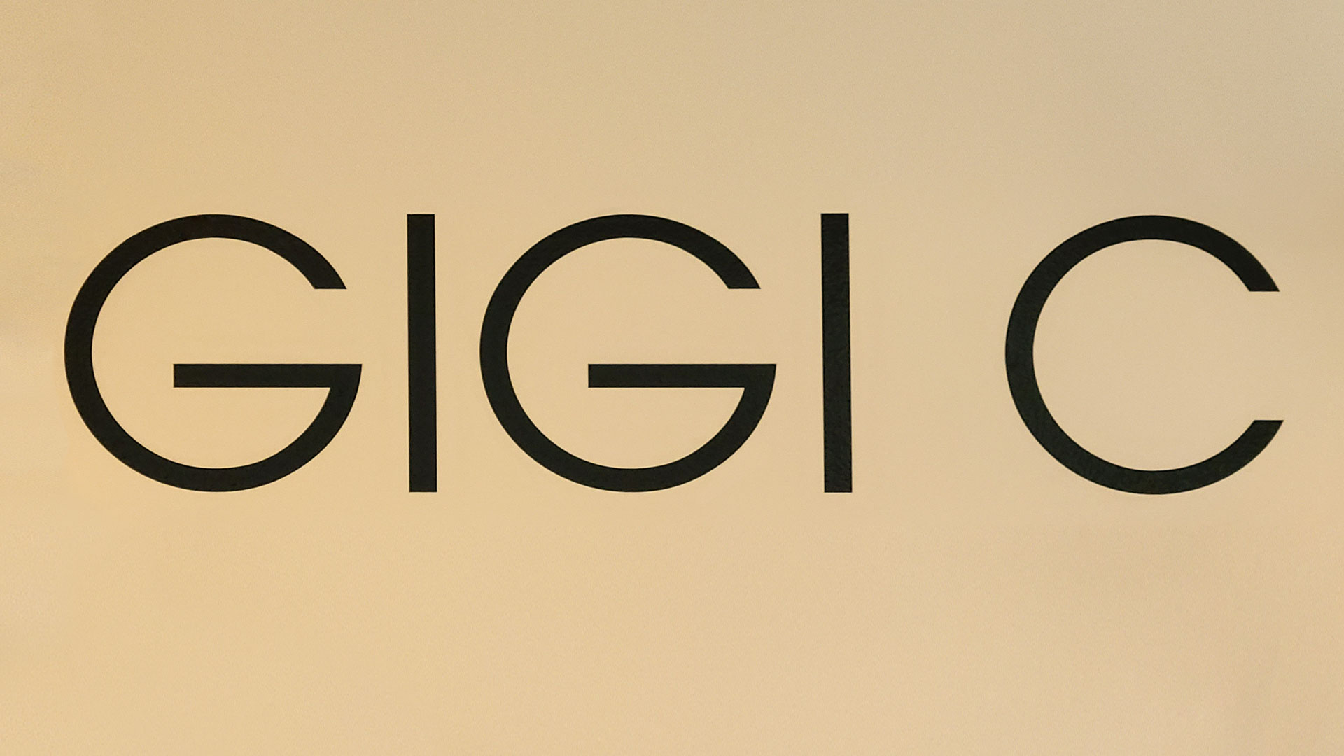 Gigi C custom interior wall lettering signage with the company name made of opaque vinyl