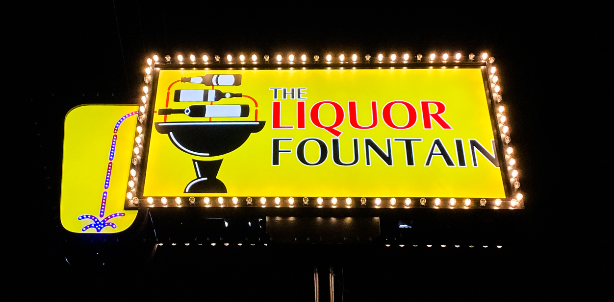 The Liquor Fountain bright yellow outdoor advertising solution