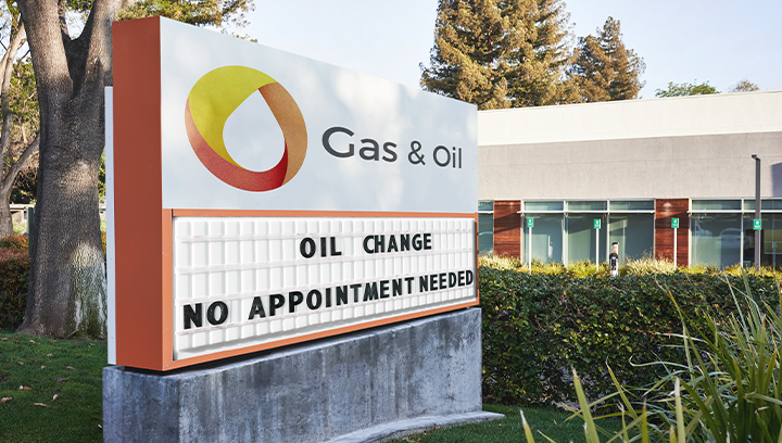 Gas & Oil changeable monument sign displaying business services outdoors