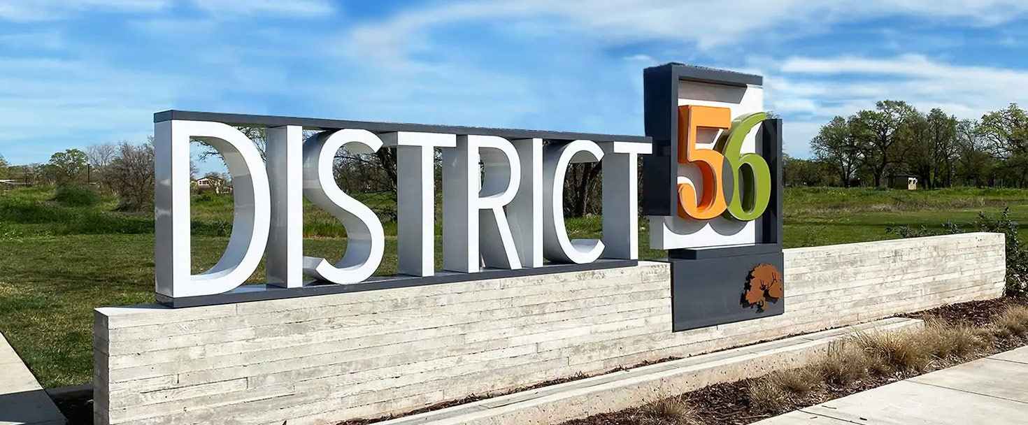 District 56 monument sign with white letters and colorful numbers made of aluminum and lexan