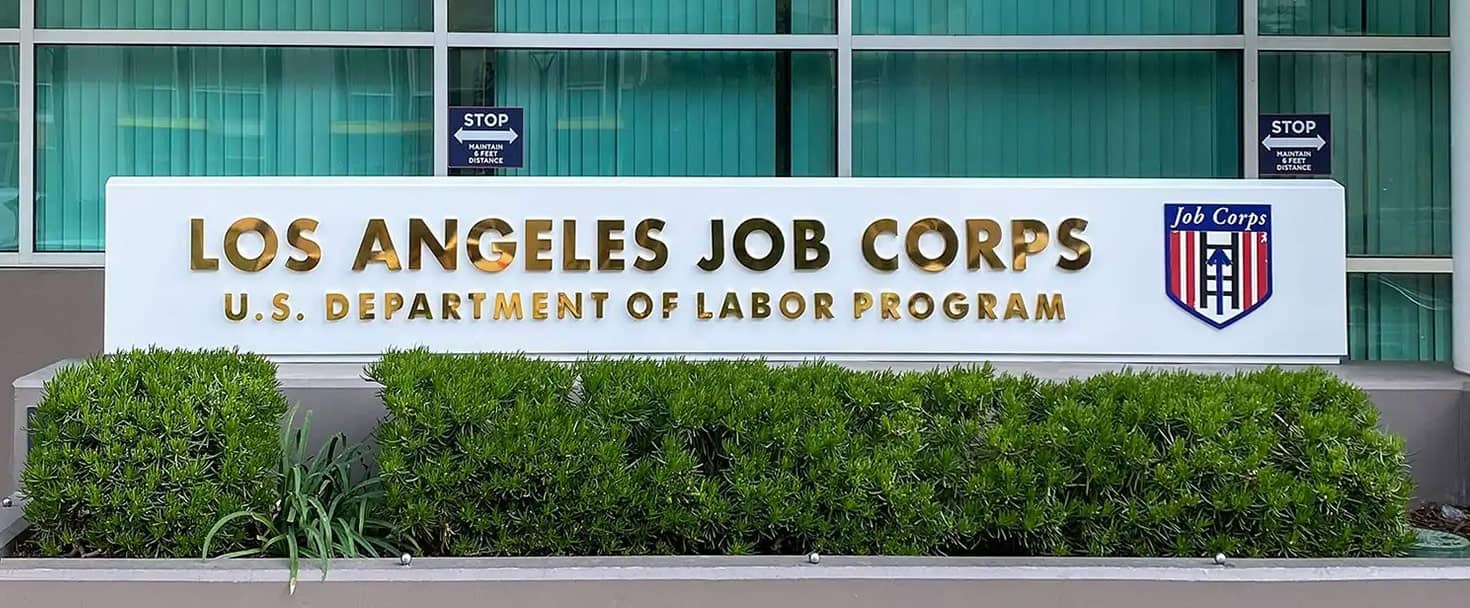 Los Angeles Job Corps monument sign displaying the agency logo and name made of polished brass