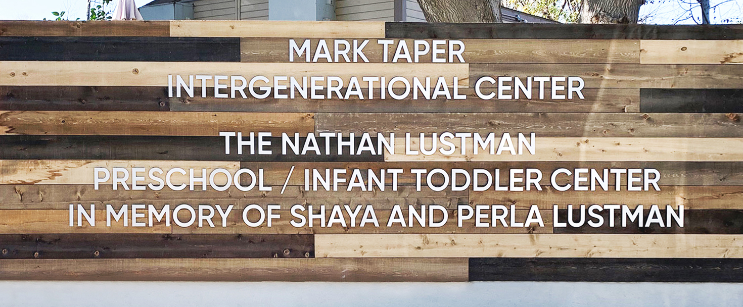Mark Taper Intergenerational Center wood monument sign displaying the center's name outdoors