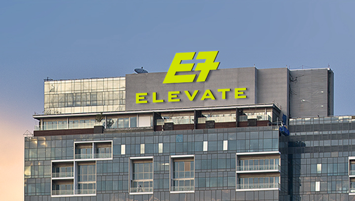 Elevate building top sign in electric green displaying the brand and logo