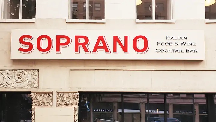 Building signs for Soprano in bold red, made of aluminum and acrylic