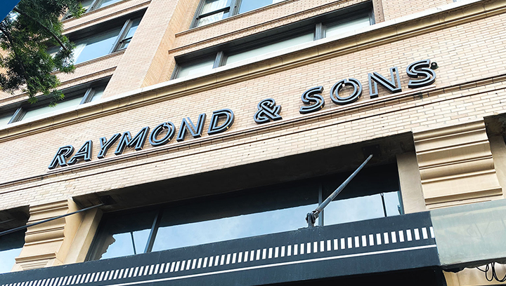 Raymond & Sons office building sign displaying the brand name made of aluminum