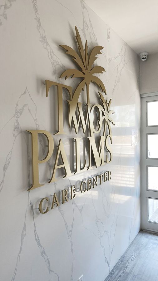 Two palms pin-mounted letters