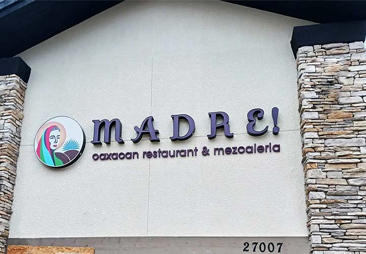 Madre outdoor sign with the brand's colorful logo and name made of aluminum, acrylic, and PVC