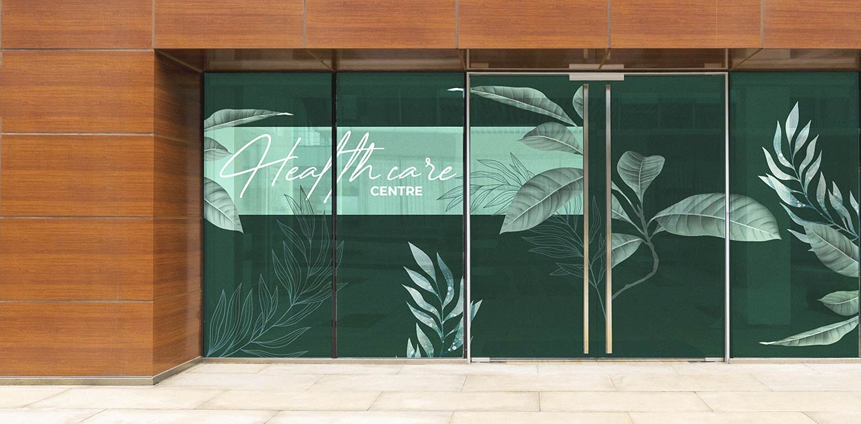 Medical office window design idea with green nature-themed graphics