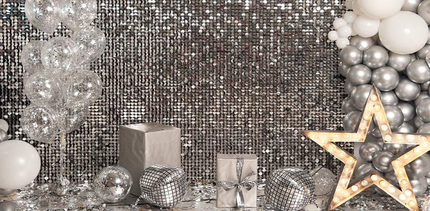 Party sequin wall backdrop in silver color with decorative balloons