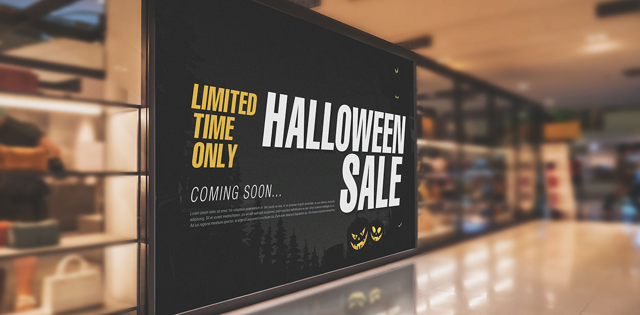 Black Halloween retail sign displaying upcoming Sales