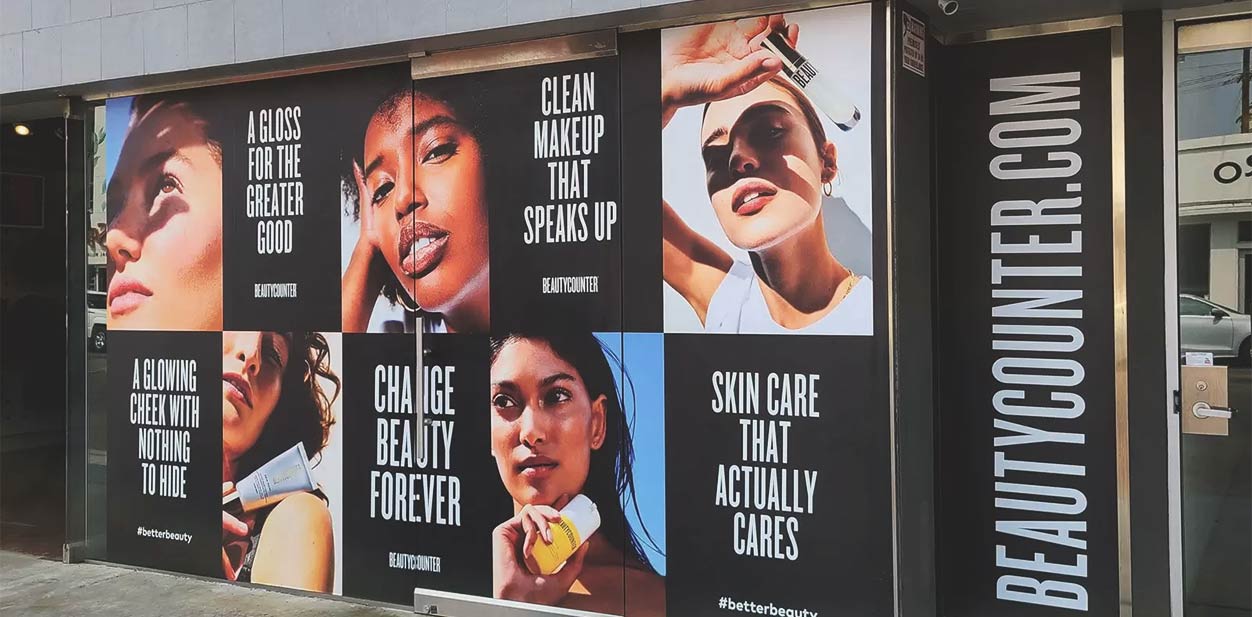 Beauty salon exterior design with female portraits displayed on windows