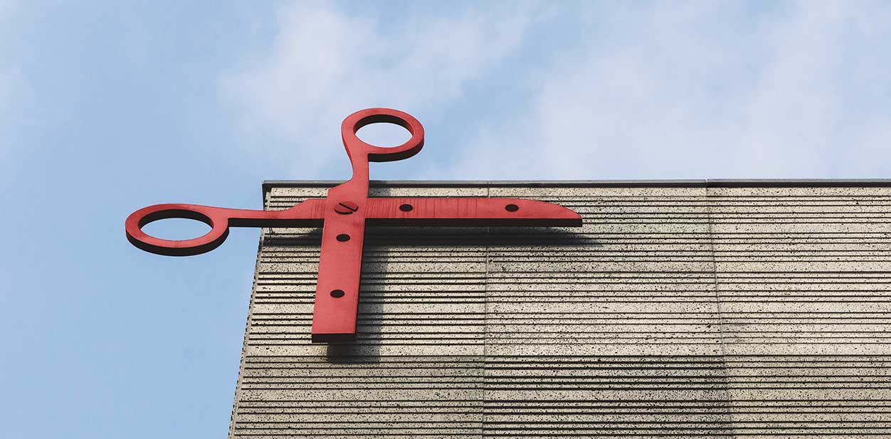 Hair salon design idea with a big red scissor display at the facade