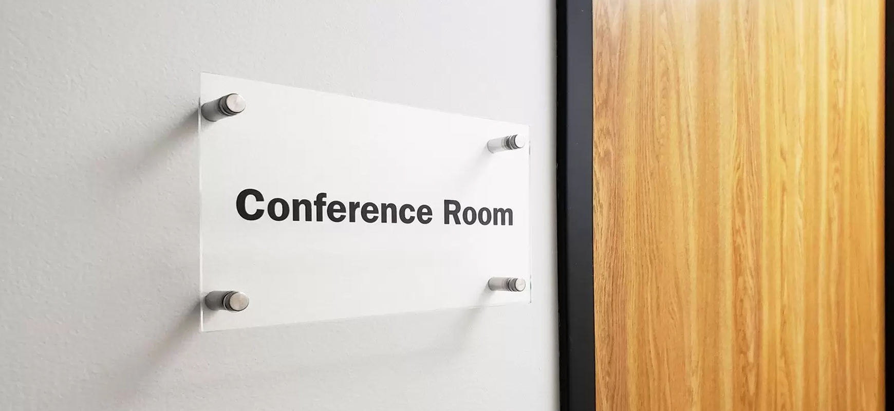 Acrylic conference nameplate with standoffs for meeting rooms