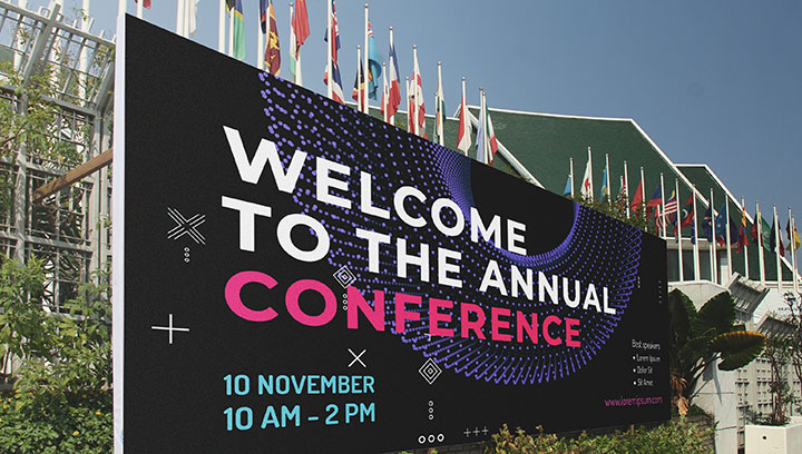 Large outdoor conference welcome sign with event data