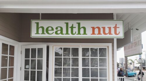 health nut hanging aluminum sign