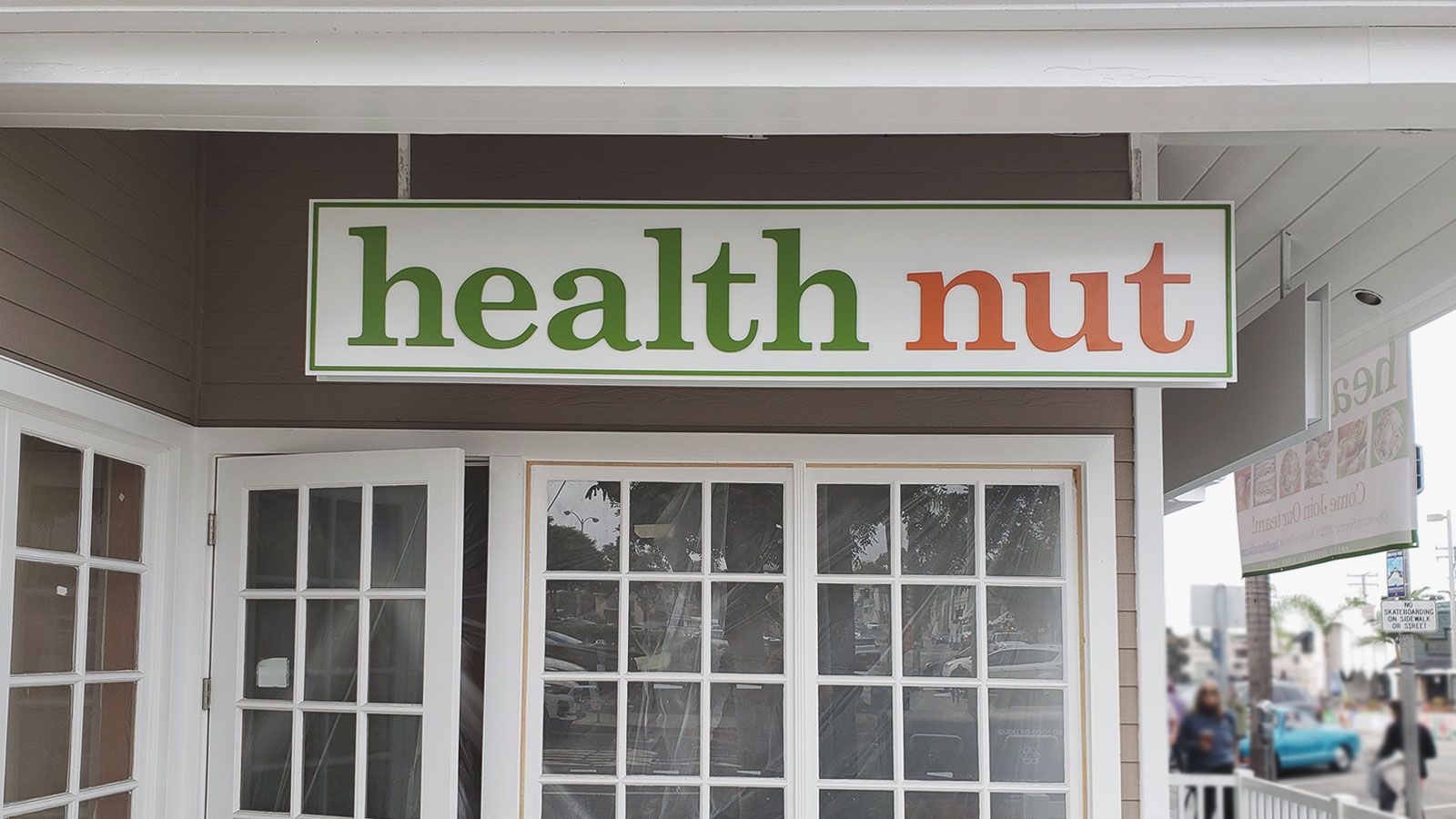 health nut hanging aluminum sign