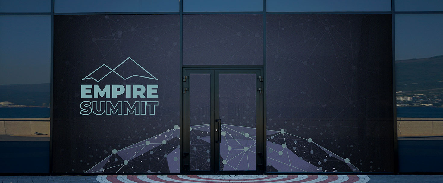 Meeting signage with graphics on doors and windows with the writing 'Empire Summit'