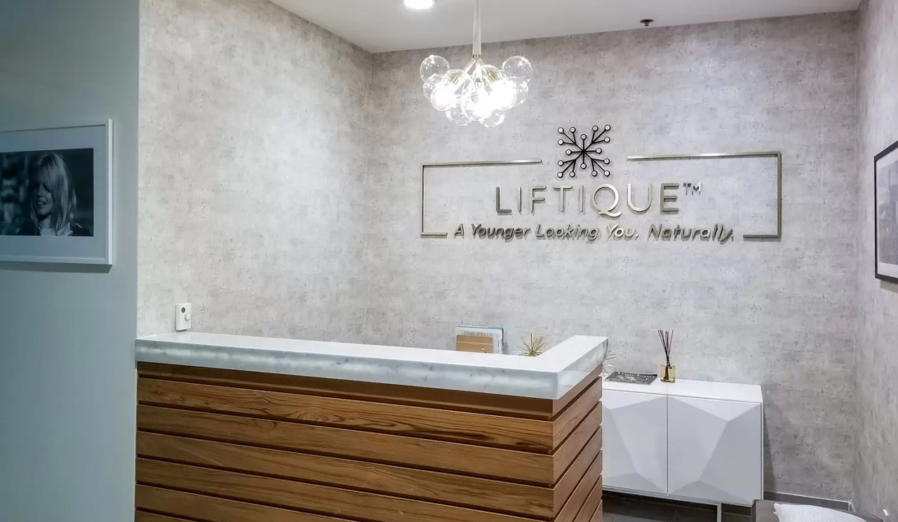 Lobby space design for reception area with logo and company name 'LIFTIQUE'