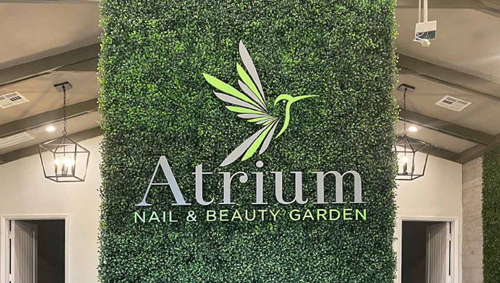 Atrium decorative beauty salon sign on a grass background wall
