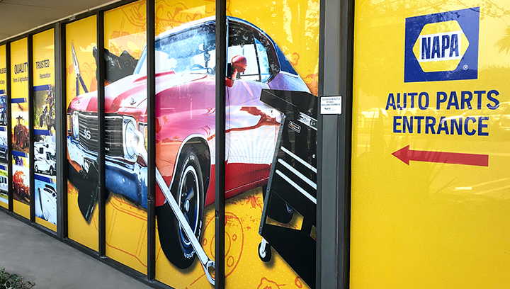 Napa branded window directional sign pointing at the entrance made of perforated vinyl