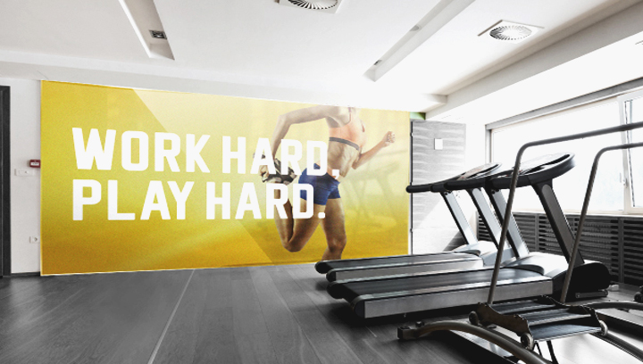 Decorative gym sign in yellow displayed at the exercise room