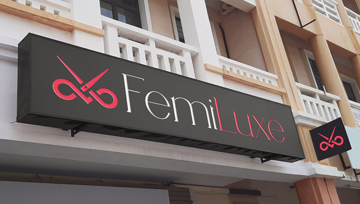 FemiLuxe salon sign board in black with pink and white letters