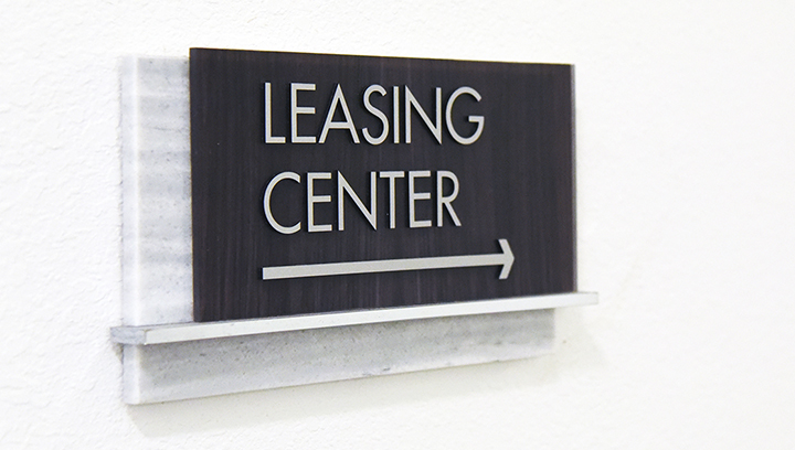 Leasing Center office directional sign fixed to the wall
