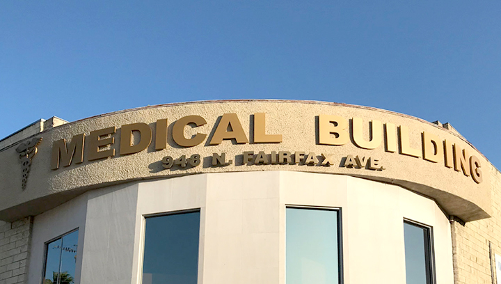 Golden colored medical building signs in a big size