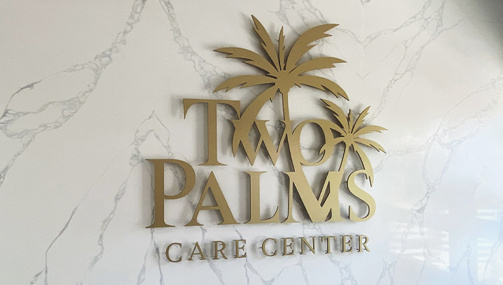 Two Palms Care Center medical clinic decoration sign in golden color