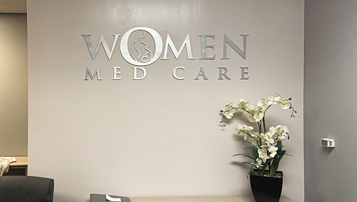 Women Med Care clinic reception sign made of aluminum