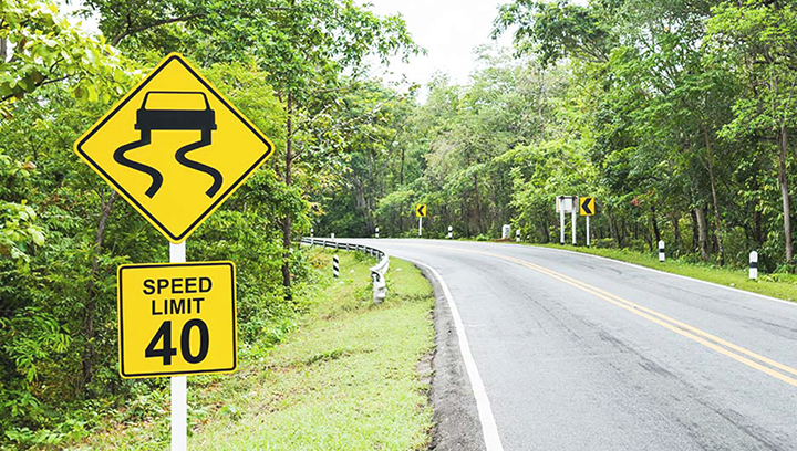 Regulatory wayfinding signs in yellow displayed at the roadside