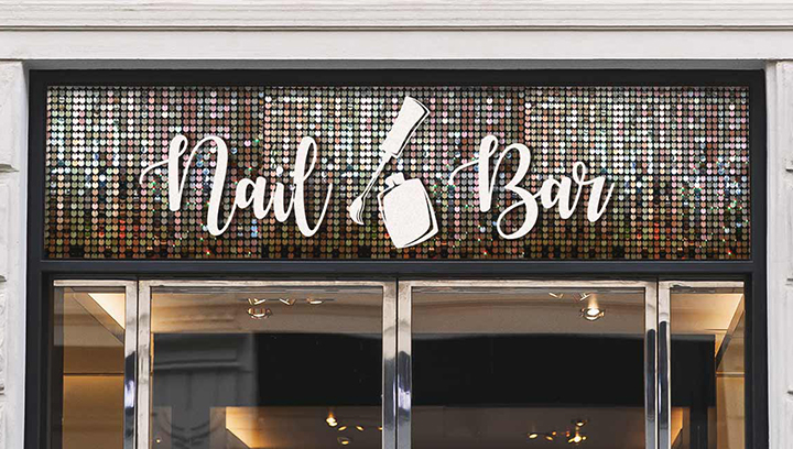 Shiny nail salon sign displaying the brand name and logo