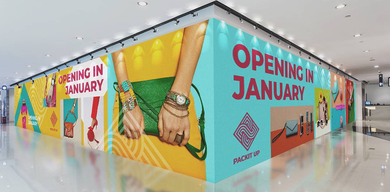 Indoor shop hoarding design with images of accessories, bags, logo and company's name 'Packit Up'