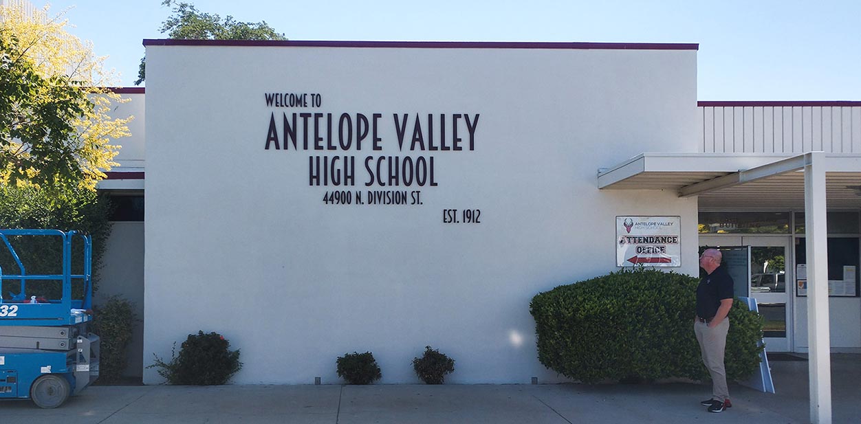 Antelope Valley high school signage design with black letters on the white wall