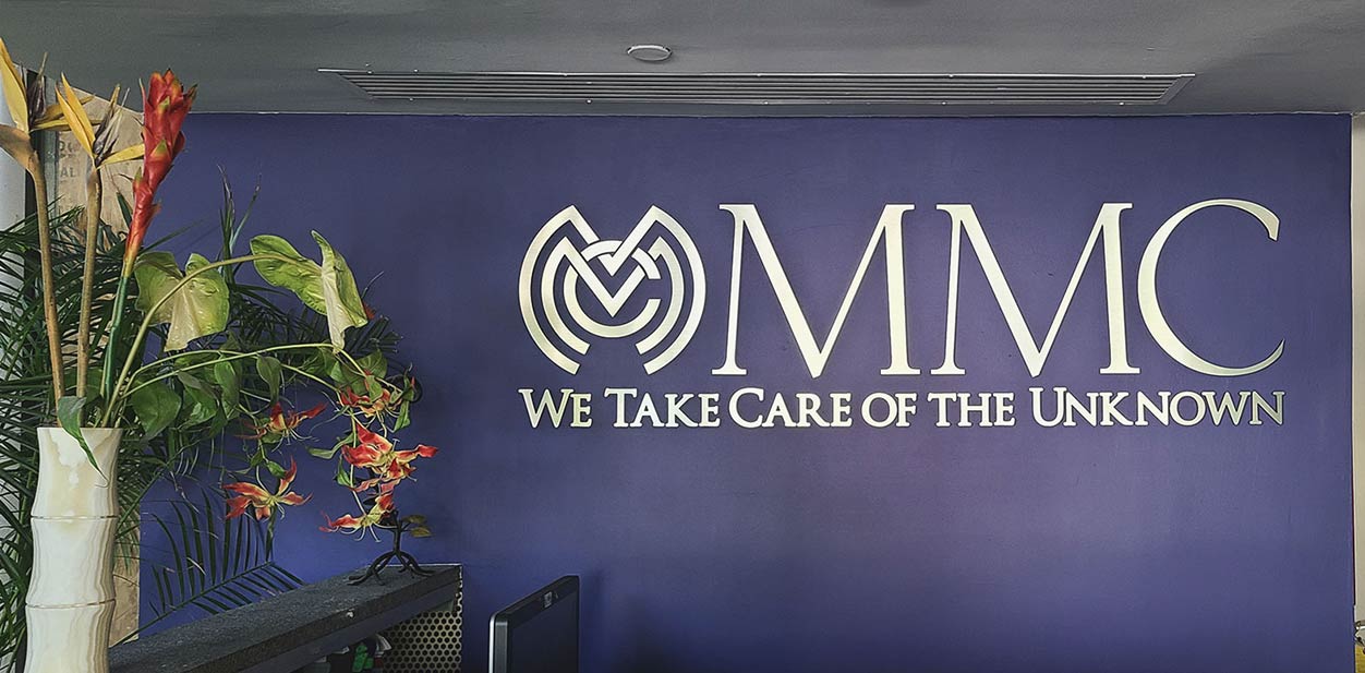 MMC best office lobby design with the text 'We Take Care Of The Unknown' and the company's logo