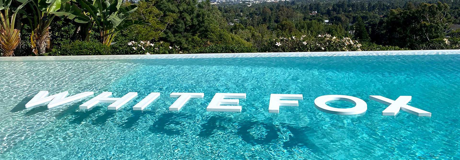 Event branding with floating letters in a pool