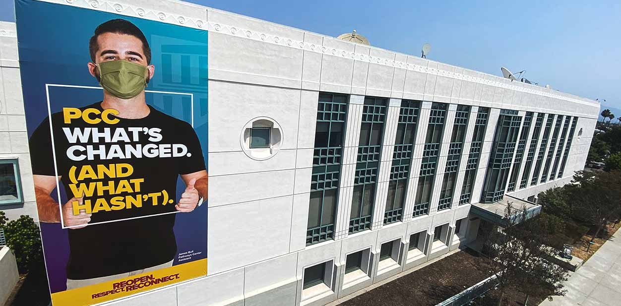 Outdoor campus branding solution on the building facade portraying a man