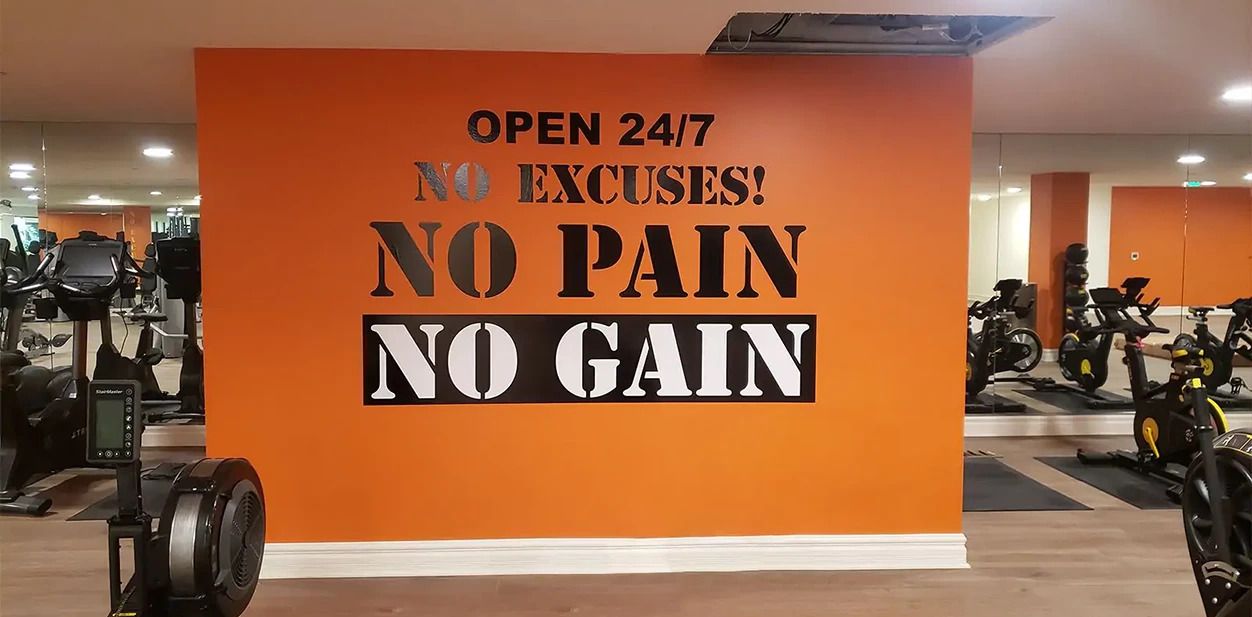 Office gym branding motivational sticky quotes on an orange wall